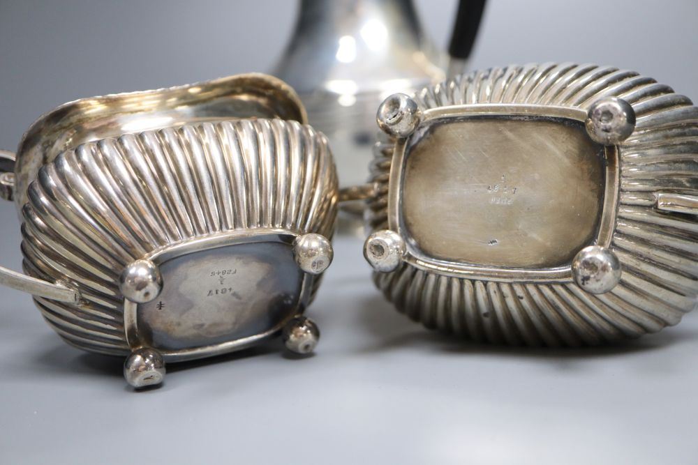 A matched late 19th/early 20th century demi-fluted silver three piece tea set, Sheffield, 1899 & London, 1901, gross 21.5 oz.